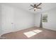 Bright bedroom with a ceiling fan, natural light and plenty of space for furniture at 4143 E Sidesaddle Rd, San Tan Valley, AZ 85140