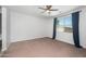 Large bedroom with a ceiling fan, carpet floors, and a lot of natural light at 4143 E Sidesaddle Rd, San Tan Valley, AZ 85140