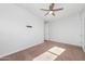 A bedroom that features light, space, and includes a ceiling fan and plush carpeting at 4143 E Sidesaddle Rd, San Tan Valley, AZ 85140