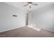 Comfortable bedroom features a fan, plush carpeting and ample space at 4143 E Sidesaddle Rd, San Tan Valley, AZ 85140