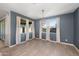 Bright dining room with backyard views and modern lighting fixture at 4143 E Sidesaddle Rd, San Tan Valley, AZ 85140