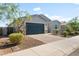 Inviting exterior view showcasing a well-maintained lawn, mature landscaping, and a paved driveway at 4143 E Sidesaddle Rd, San Tan Valley, AZ 85140