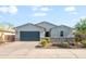 Charming single-story home featuring a neatly manicured yard and a stylish stone accent wall at 4143 E Sidesaddle Rd, San Tan Valley, AZ 85140