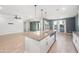 Kitchen island with stainless steel sink, granite countertops, and white cabinets at 4143 E Sidesaddle Rd, San Tan Valley, AZ 85140