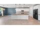 Modern kitchen features an island with granite countertops, stainless appliances, and pendant lighting at 4143 E Sidesaddle Rd, San Tan Valley, AZ 85140