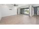Bright living room with neutral tile flooring and large sliding glass doors to the backyard at 4143 E Sidesaddle Rd, San Tan Valley, AZ 85140
