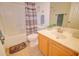 Well-lit bathroom featuring a shower-tub combo and a sink with wooden cabinetry at 639 E Palo Verde St, Casa Grande, AZ 85122