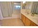 Well-lit bathroom with double sinks, tub, and glass-enclosed shower at 639 E Palo Verde St, Casa Grande, AZ 85122