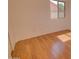 A bedroom featuring wood laminate flooring and a sunlit window at 639 E Palo Verde St, Casa Grande, AZ 85122