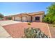 The exterior showcases a low-maintenance desert landscape complementing the home's facade and three-car garage at 639 E Palo Verde St, Casa Grande, AZ 85122