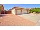 A single-story home features a spacious three-car garage and low-maintenance desert landscaping at 639 E Palo Verde St, Casa Grande, AZ 85122