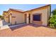 A covered entrance to the house features a desert rock yard and well maintained landscaping at 639 E Palo Verde St, Casa Grande, AZ 85122