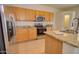 A well-lit kitchen features wood cabinets, granite countertops, and stainless-steel appliances at 639 E Palo Verde St, Casa Grande, AZ 85122