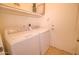 A laundry room including both a washer and dryer plus upper cabinets at 639 E Palo Verde St, Casa Grande, AZ 85122
