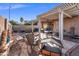 Backyard featuring a covered patio, fire pit, multiple seating areas, and desert landscaping at 671 W Jahns Ct, Casa Grande, AZ 85122