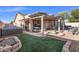 Inviting backyard with covered patio, outdoor seating, a built-in fire pit, and desert landscaping at 671 W Jahns Ct, Casa Grande, AZ 85122