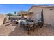 Backyard features a covered patio, gravel and artificial grass areas, and ample seating space at 671 W Jahns Ct, Casa Grande, AZ 85122