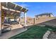 Backyard with a covered patio, lounge area, and low-maintenance landscaping, perfect for outdoor living at 671 W Jahns Ct, Casa Grande, AZ 85122