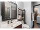 Bathroom featuring a single sink vanity, decorative mirror, shelving unit, and a toilet at 671 W Jahns Ct, Casa Grande, AZ 85122