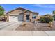 Single-story home featuring desert landscaping, a tile roof, and a blue front door at 671 W Jahns Ct, Casa Grande, AZ 85122
