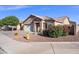 Charming single-story home featuring desert landscaping, a tile roof, and a two-car garage at 671 W Jahns Ct, Casa Grande, AZ 85122
