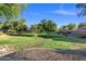 Lush green space with mature trees, manicured lawn, and well-maintained landscaping, ideal for recreation at 671 W Jahns Ct, Casa Grande, AZ 85122