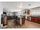 Open-concept kitchen with a center island, breakfast bar, and stainless steel appliances at 671 W Jahns Ct, Casa Grande, AZ 85122