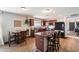 Open kitchen featuring dark wood cabinets, a breakfast bar, and stainless steel appliances at 671 W Jahns Ct, Casa Grande, AZ 85122
