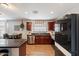 Well-lit kitchen with stainless steel appliances and dark wood cabinetry at 671 W Jahns Ct, Casa Grande, AZ 85122