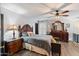 Spacious bedroom with dark wood furniture and ceiling fan at 671 W Jahns Ct, Casa Grande, AZ 85122
