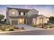 Inviting two-story home with a three-car garage, desert landscaping, and a neutral color palette at 7131 W Oberlin Way, Peoria, AZ 85383