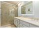 This bathroom features double sinks, white cabinets, and glass enclosed tiled shower at 7324 S Bonarden Ln, Tempe, AZ 85283