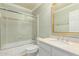 Full bathroom with combined shower and tub, white cabinets and large vanity mirror at 7324 S Bonarden Ln, Tempe, AZ 85283