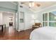 This bedroom features natural light, ceiling fan, hardwood floor, and an interior storage area at 7324 S Bonarden Ln, Tempe, AZ 85283