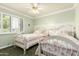 Bright bedroom with twin beds, natural light, ceiling fan, and wainscoting at 7324 S Bonarden Ln, Tempe, AZ 85283