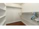 This is a walk-in closet with wood floor, shelves and hanging racks at 7324 S Bonarden Ln, Tempe, AZ 85283