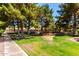 Scenic community grounds featuring mature trees, lush green lawns, and inviting walking paths for residents to enjoy at 7324 S Bonarden Ln, Tempe, AZ 85283