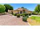 Exterior showcasing desert landscaping, a tile roof, and a charming gated courtyard at 7324 S Bonarden Ln, Tempe, AZ 85283