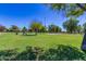 Expansive park with lush green lawns, mature trees, and recreational facilities, providing ample space for outdoor activities at 7324 S Bonarden Ln, Tempe, AZ 85283
