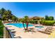 Community pool and spa surrounded by palm trees and lounge chairs, offering a resort-style atmosphere for relaxation at 7324 S Bonarden Ln, Tempe, AZ 85283