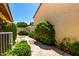 Well-manicured yard featuring lush landscaping, mature shrubs, and a serene pathway leading to a peaceful garden at 7324 S Bonarden Ln, Tempe, AZ 85283