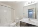 Bathroom with white tiled shower and vanity with dark brown cabinet at 854 S San Marcos Bldg 6 -- # A, Apache Junction, AZ 85120