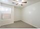 Bedroom featuring neutral carpet, ceiling fan, bright white walls, and a window at 854 S San Marcos Bldg 6 -- # A, Apache Junction, AZ 85120