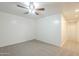 A bright bedroom features neutral carpeting, a ceiling fan, and a view into the hall at 854 S San Marcos Bldg 6 -- # A, Apache Junction, AZ 85120