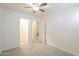 Bedroom featuring neutral carpet with a view into the hall, walk-in closet, and stairs at 854 S San Marcos Bldg 6 -- # A, Apache Junction, AZ 85120