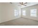 A spacious bedroom with neutral walls, carpet, and ample natural light to create a serene atmosphere at 854 S San Marcos Bldg 6 -- # A, Apache Junction, AZ 85120