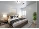 Stylishly staged bedroom with modern lamps, decor, a plush bed, and a neutral color palette at 854 S San Marcos Dr Bldg 6 Dr # D, Apache Junction, AZ 85120