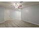 Neutral bedroom with a ceiling fan, gray carpet, and a white door at 854 S San Marcos Dr Bldg 6 Dr # D, Apache Junction, AZ 85120