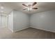Neutral bedroom with a ceiling fan, gray carpet, and a hallway at 854 S San Marcos Dr Bldg 6 Dr # D, Apache Junction, AZ 85120