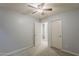 Neutral bedroom with a ceiling fan, carpet, and white doors at 854 S San Marcos Dr Bldg 6 Dr # D, Apache Junction, AZ 85120